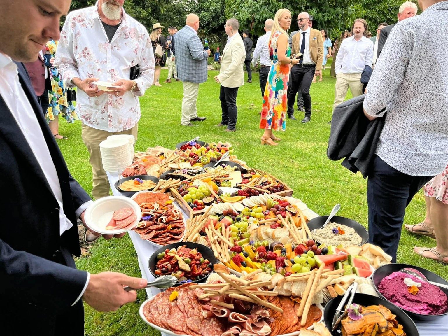 Wedding guests enjoying a Pasta Face Italian grazing table in Melbourne