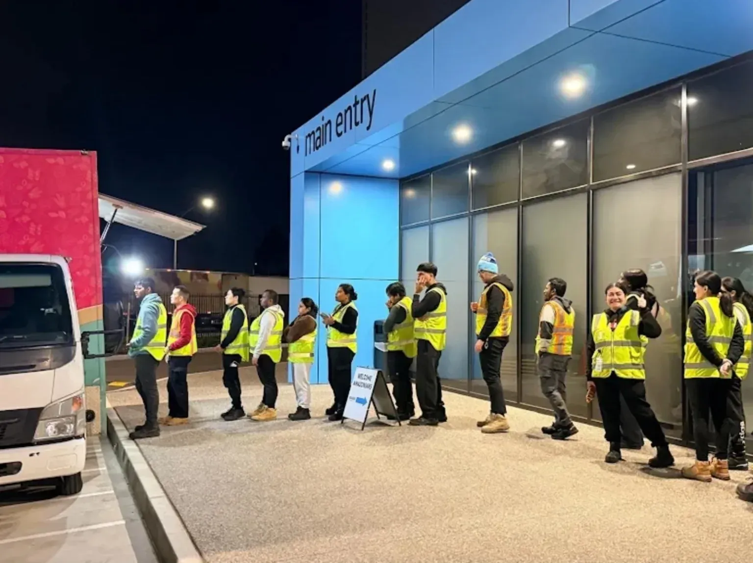 Employees queueing for Pasta Face workplace catering during an evening staff service