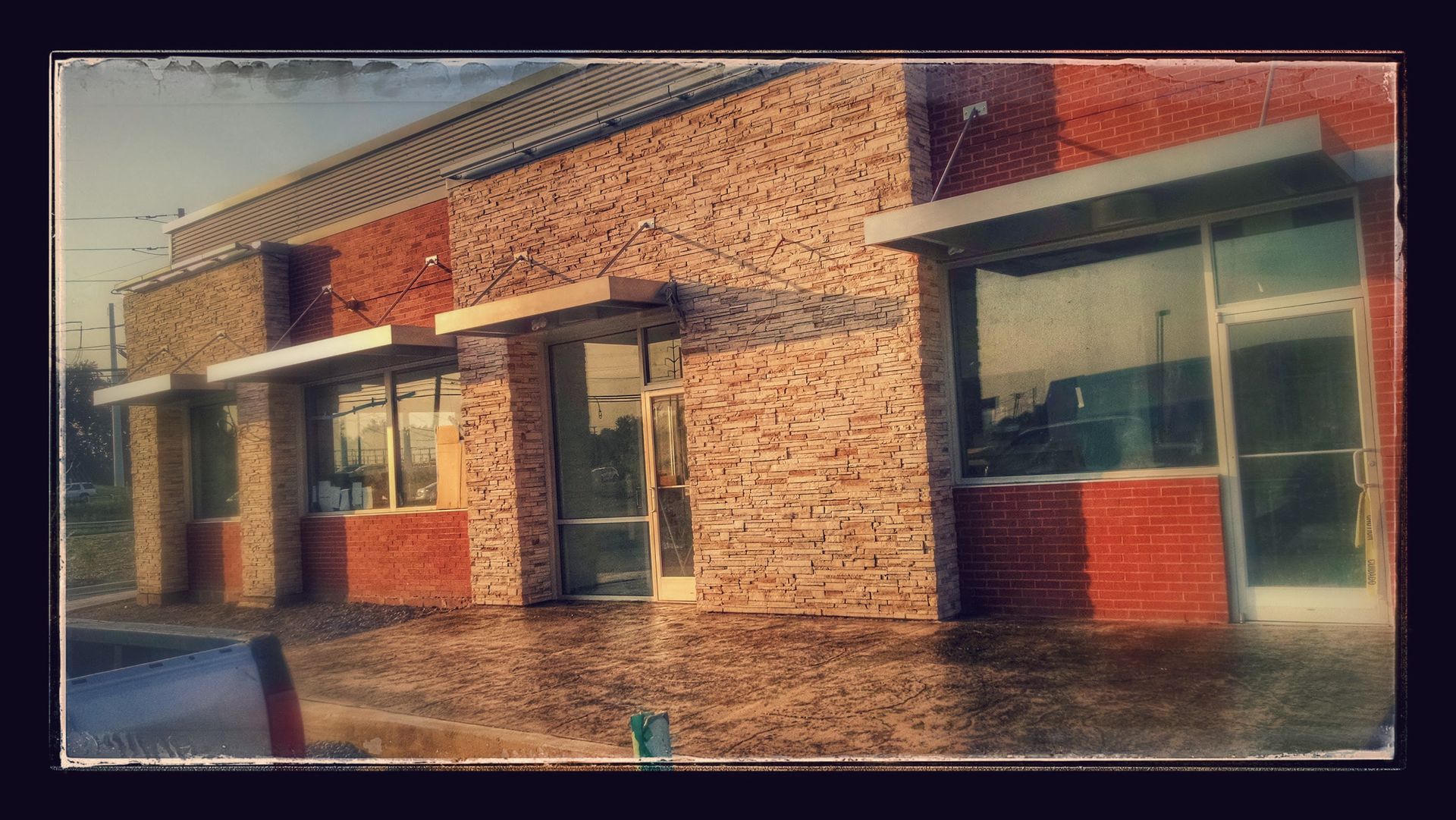 A brick building with a lot of windows and doors