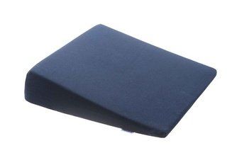 Cuscino in schiuma blu a forma di cuneo con la parte superiore inclinata su sfondo bianco.