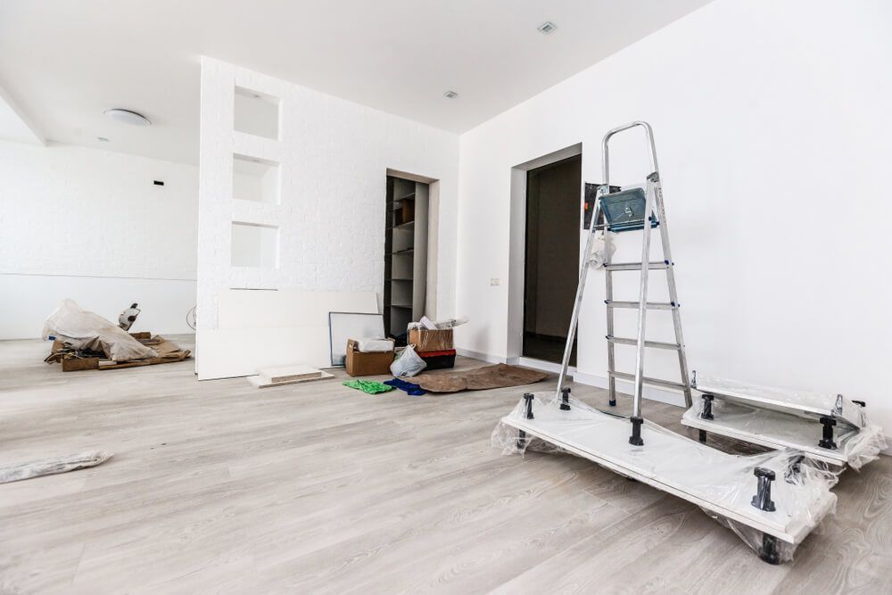 A Ladder is on Top of a Cart in an Empty Room — Cemak Constructions in Coffs Harbour, NSW