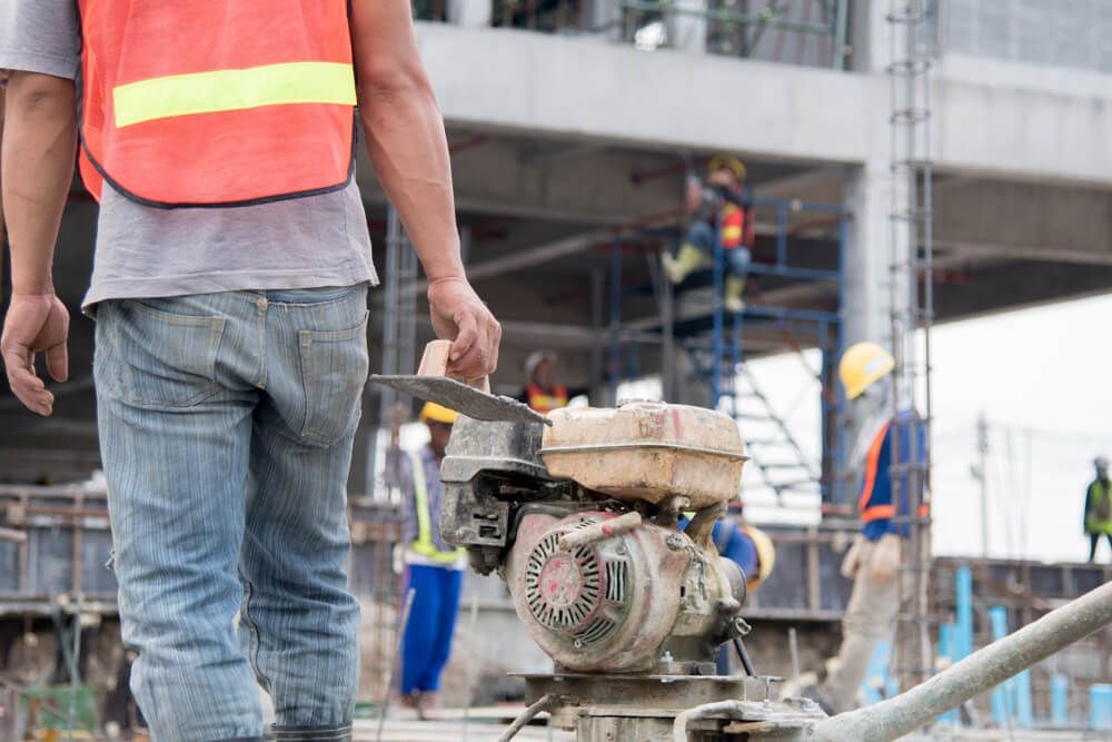 A Construction Worker is Walking on a Construction Site — Cemak Constructions in Coffs Harbour, NSW