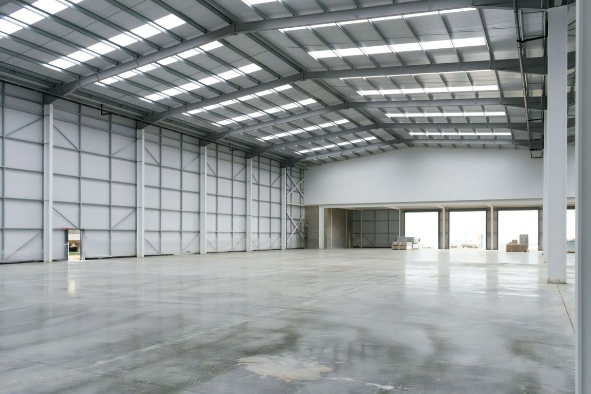 A Large Empty Warehouse with A Concrete Floor — Cemak Constructions in Port Macquarie, NSW