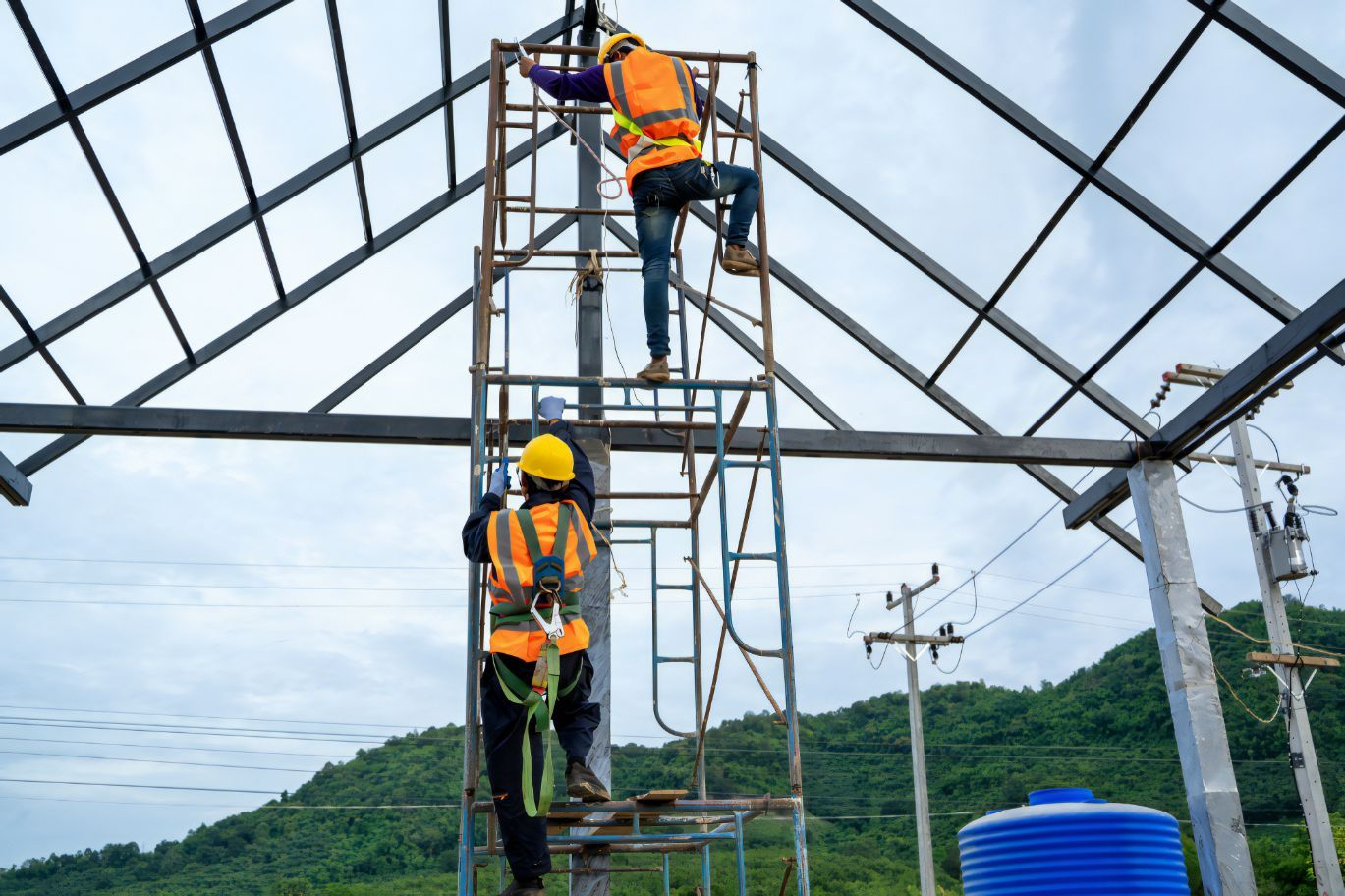 Two Construction Workers Are Working on A Metal Structure — Cemak Constructions in Nambucca Heads, NSW