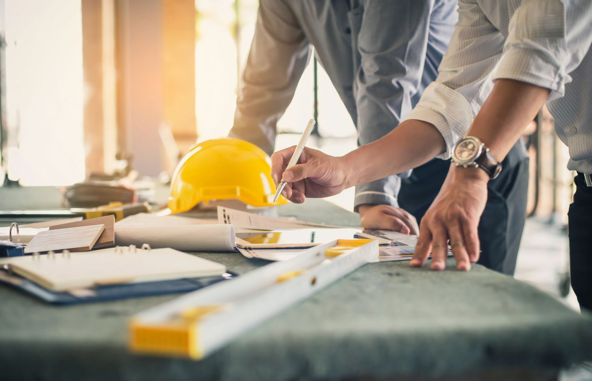 Two Men Are Working on A Construction Project at A Table — Cemak Constructions in Port Macquarie, NSW
