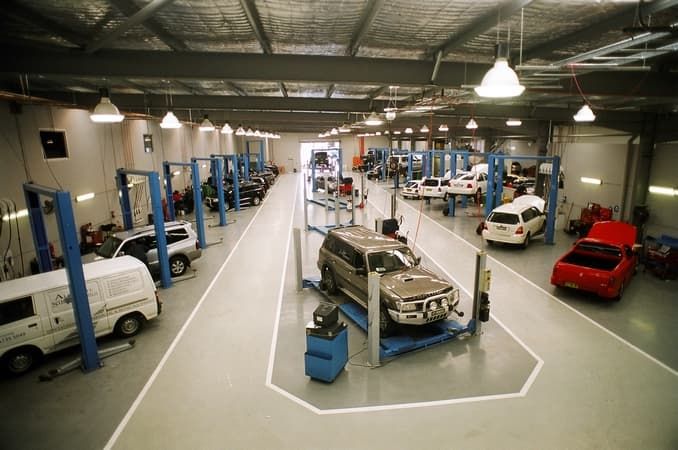 A Car Is Sitting on A Lift in A Garage — Cemak Constructions in Port Macquarie, NSW