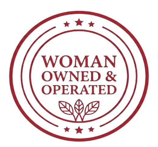 Maroon circular badge reading “Woman Owned & Operated” with small stars and leaf icon