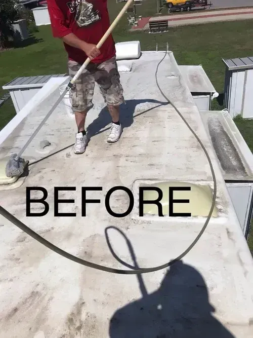 Person on a flat roof pressure washing white surface, with large “BEFORE” text overlaid.