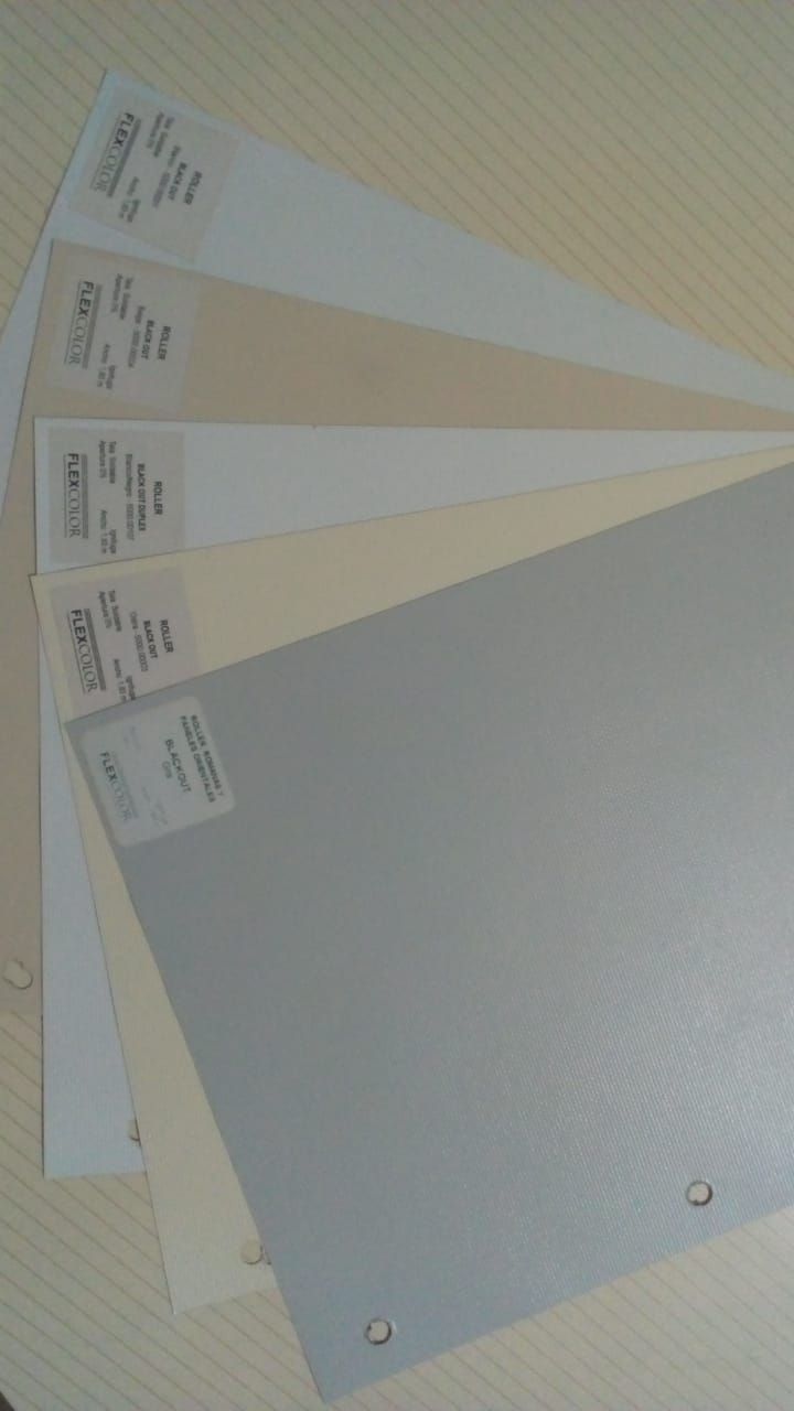 Varias tarjetas de muestra grandes, de papel gris y beige, estaban extendidas sobre una superficie clara.