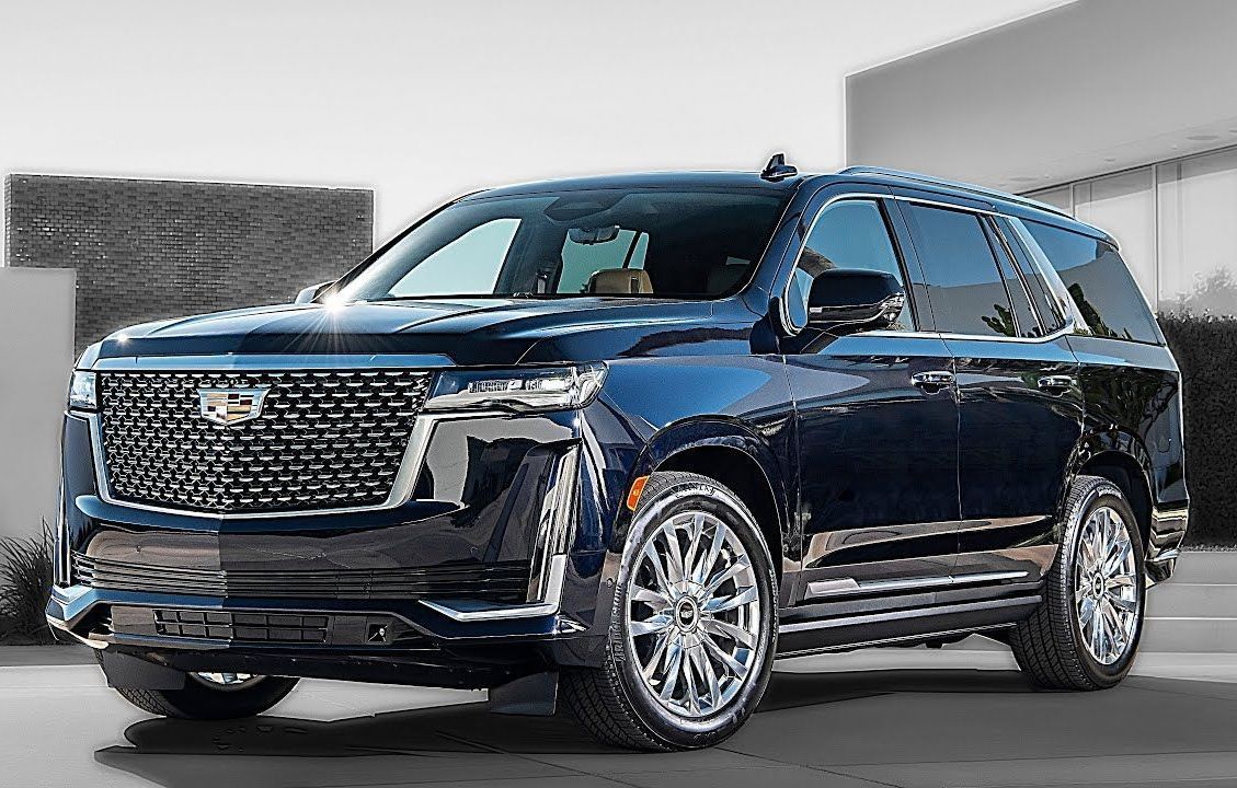 Dark blue Cadillac Escalade SUV parked outside.