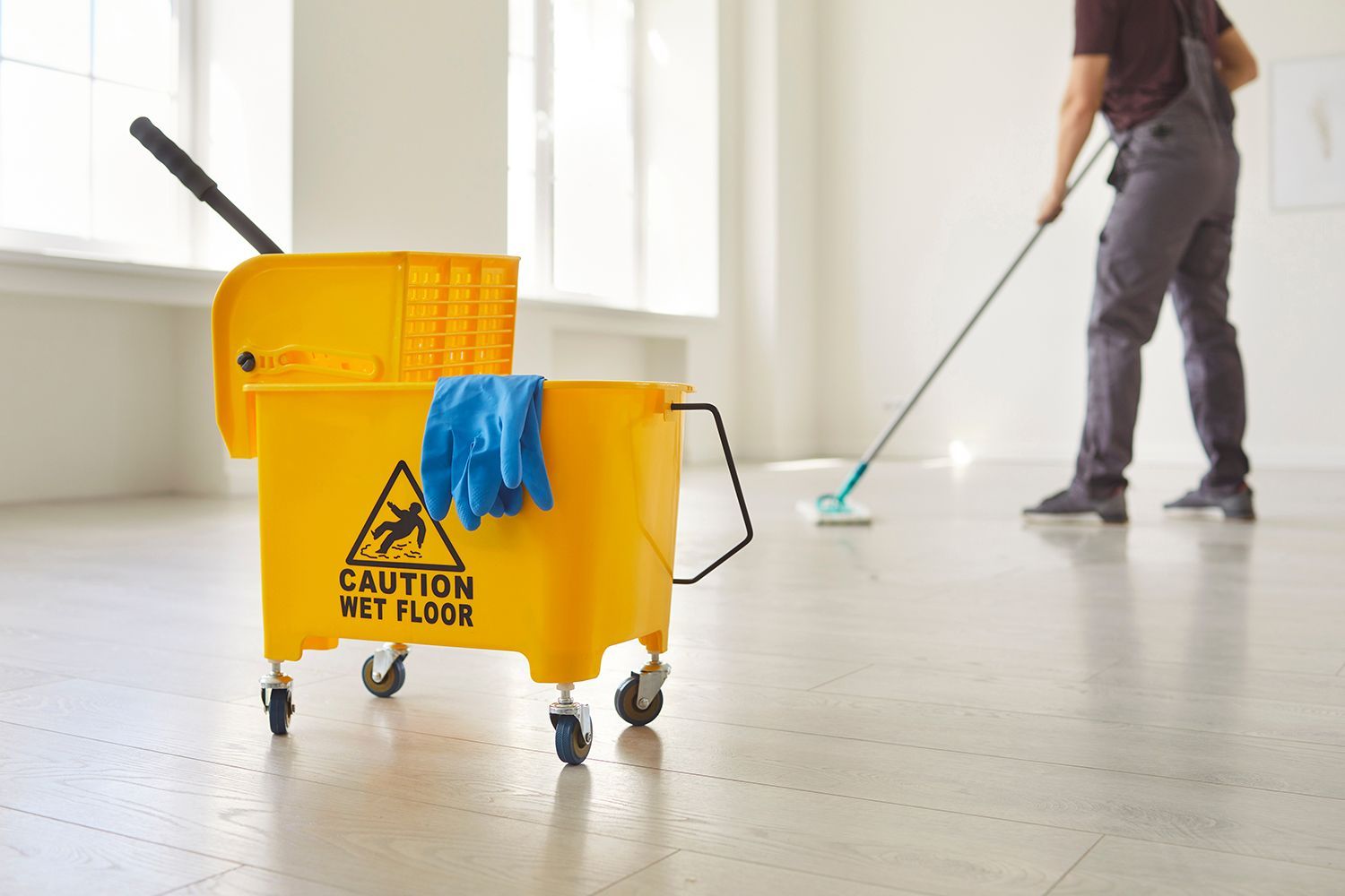 A man is mopping the floor. A man is mopping the floor.