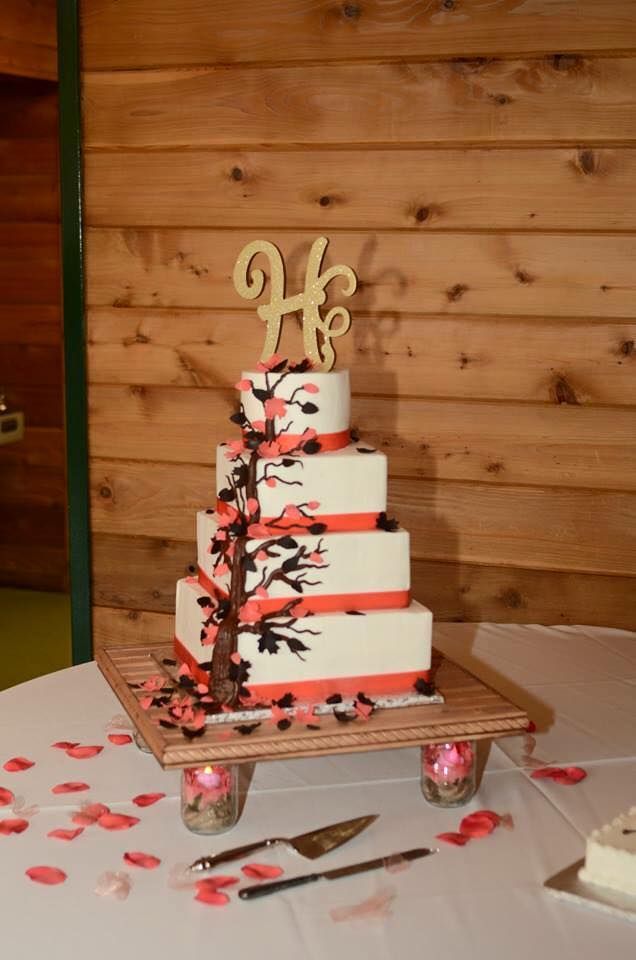 pink and white wedding cake with tree design