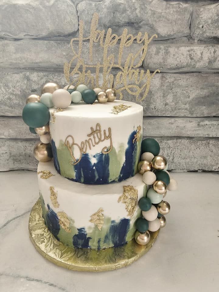 green, gold, and cream birthday cake