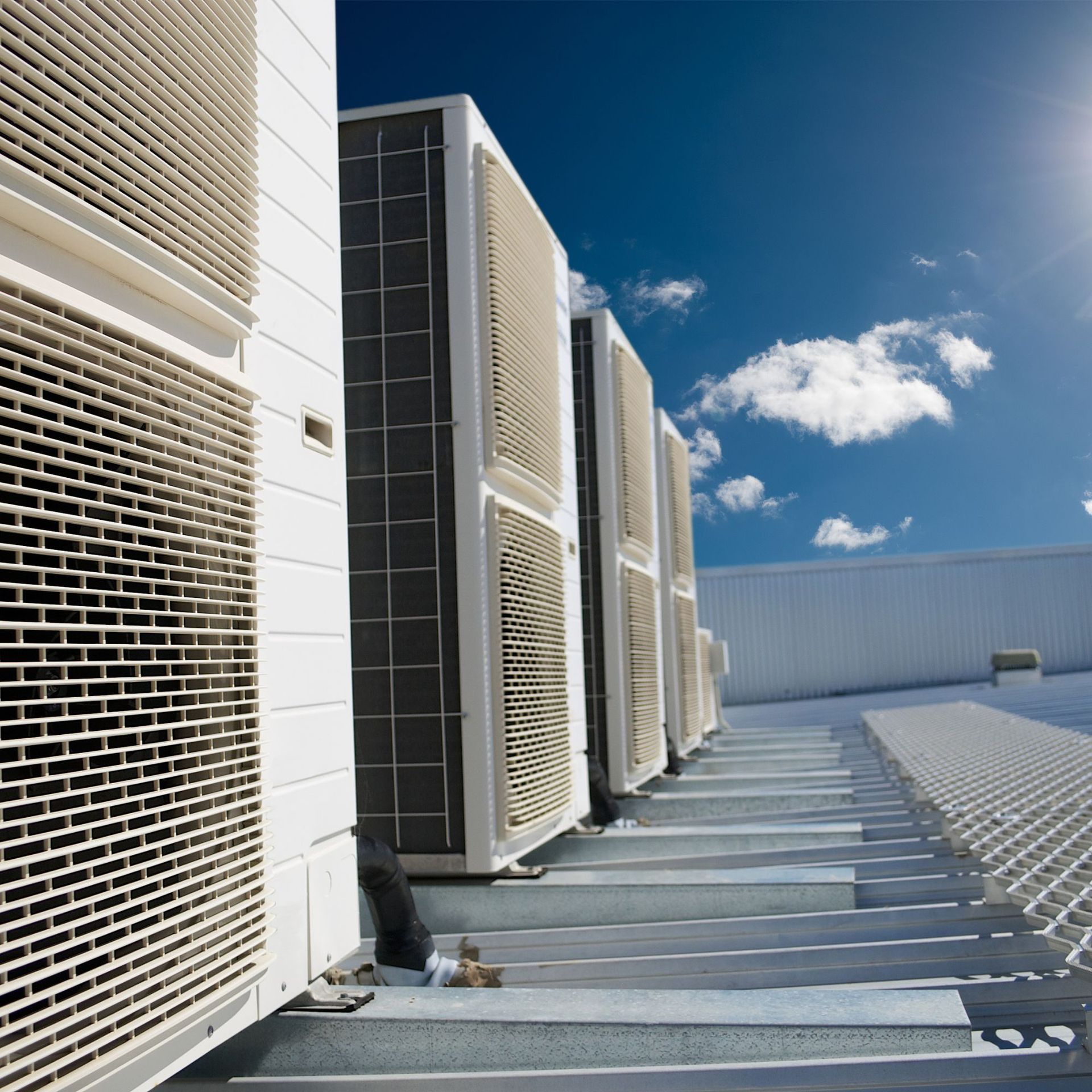 CC Air Services LLC - A row of air conditioners on the side of a building