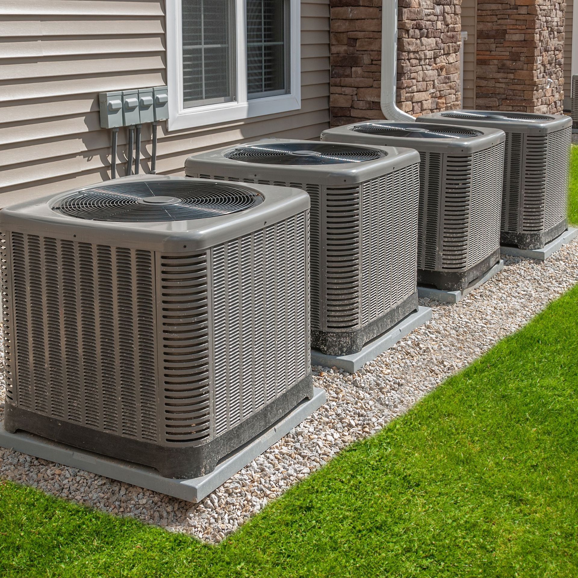 CC Air Services LLC - Three air conditioners are sitting on the side of a house.