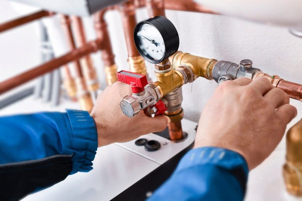 A Plumber is Working on a Pipe With a Gauge on It — Darwin’s Gas Man in Nightcliff, NT