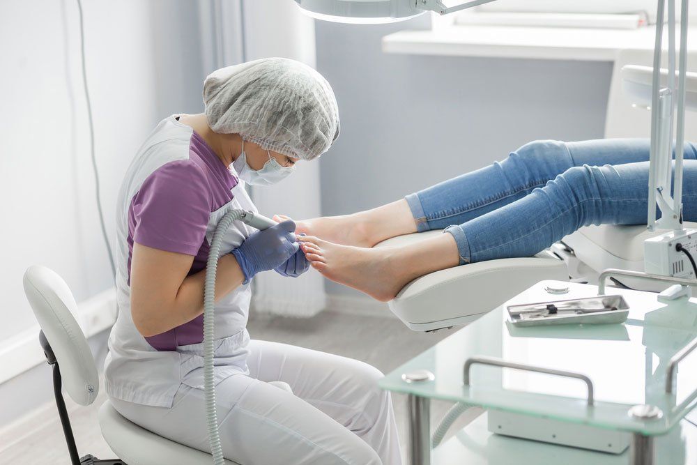 Podiatrist Treating Injured Toenail — Podiatry In Forster, NSW