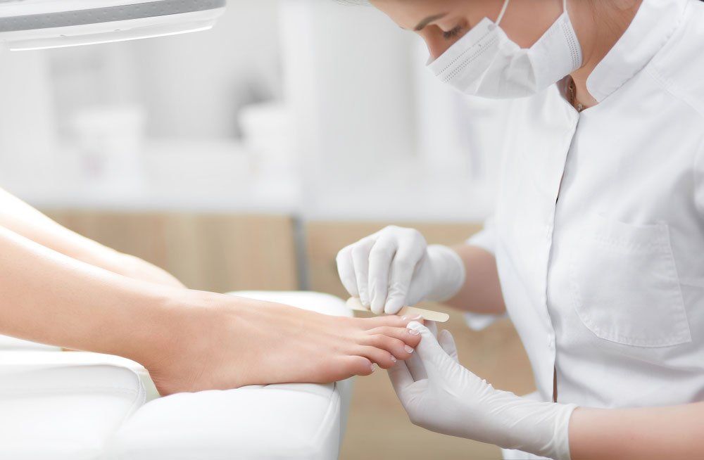 Podiatrist Treating Nails — Podiatry In Forster, NSW