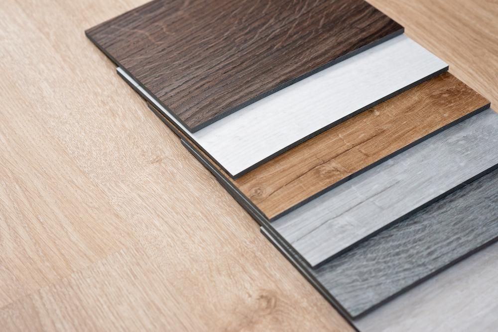 A Stack Of Different Types Of Wooden Flooring On A Wooden Floor — B2B Flooring Solutions In Forster, NSW