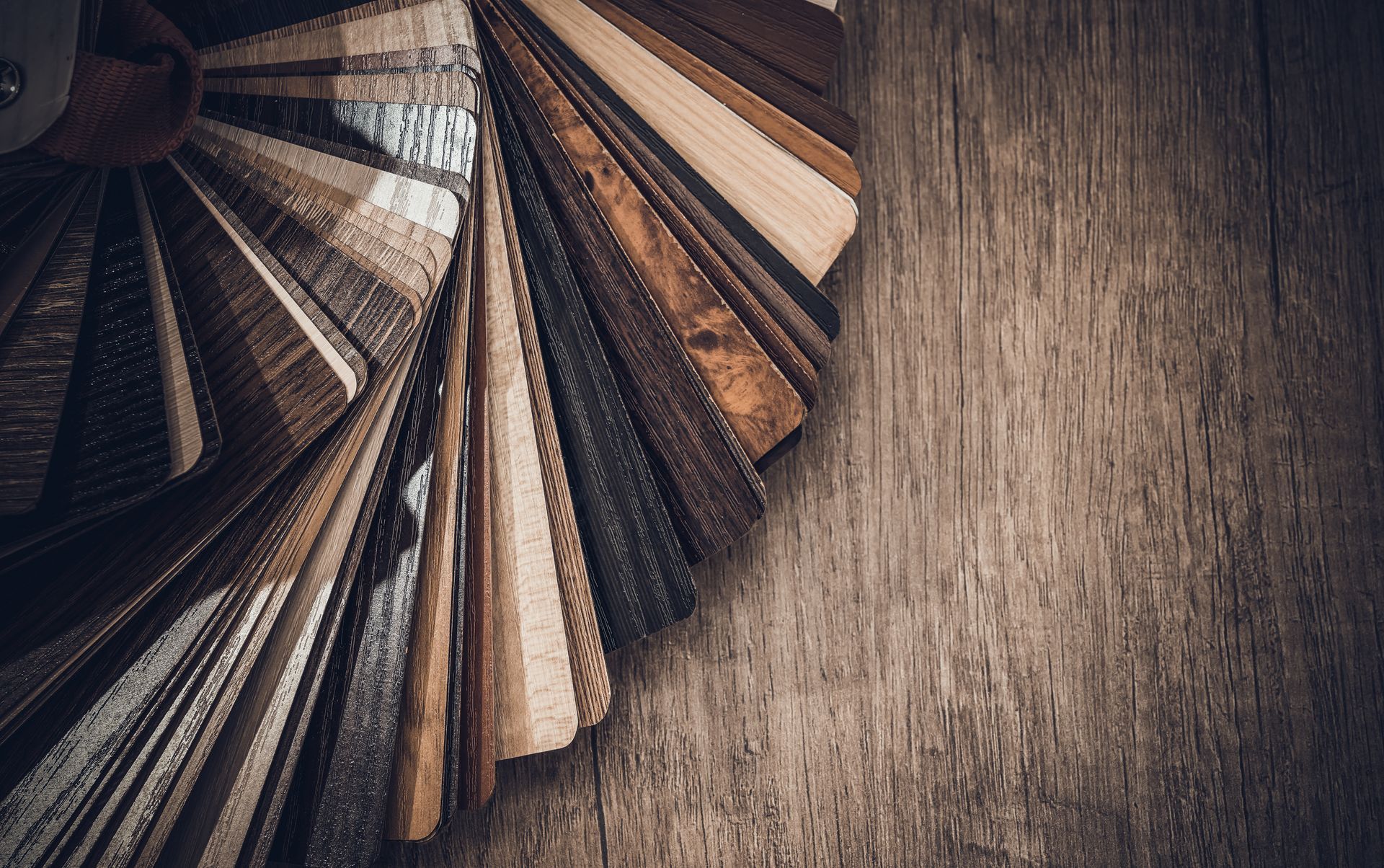 A Fan Of Wood Samples On A Wooden Table — B2B Flooring Solutions In Port Macquarie, NSW