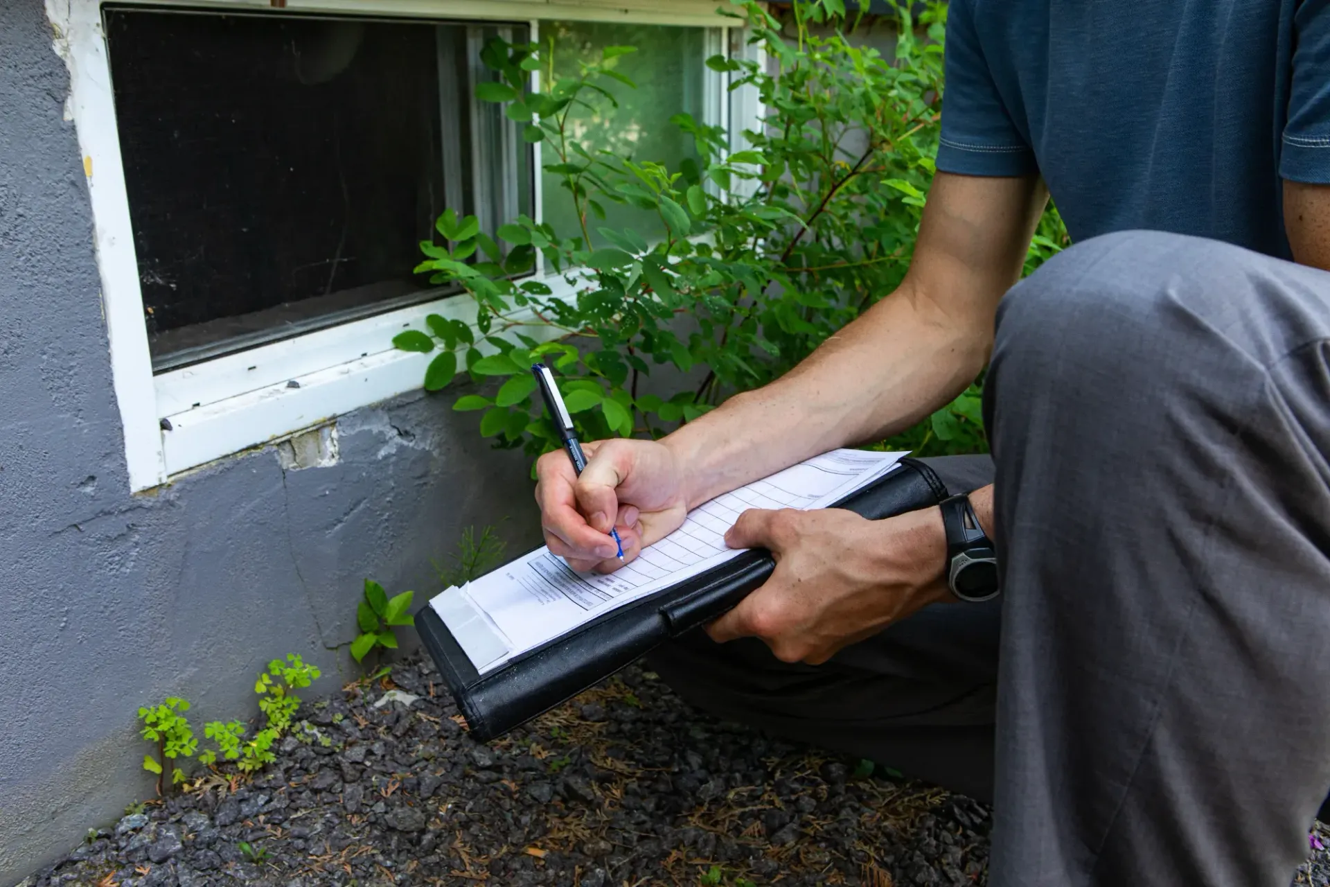 Person Kneeling by A House Wall, Writing on A Clipboard  — HYVIS Pty Ltd in Mulambin, QLD