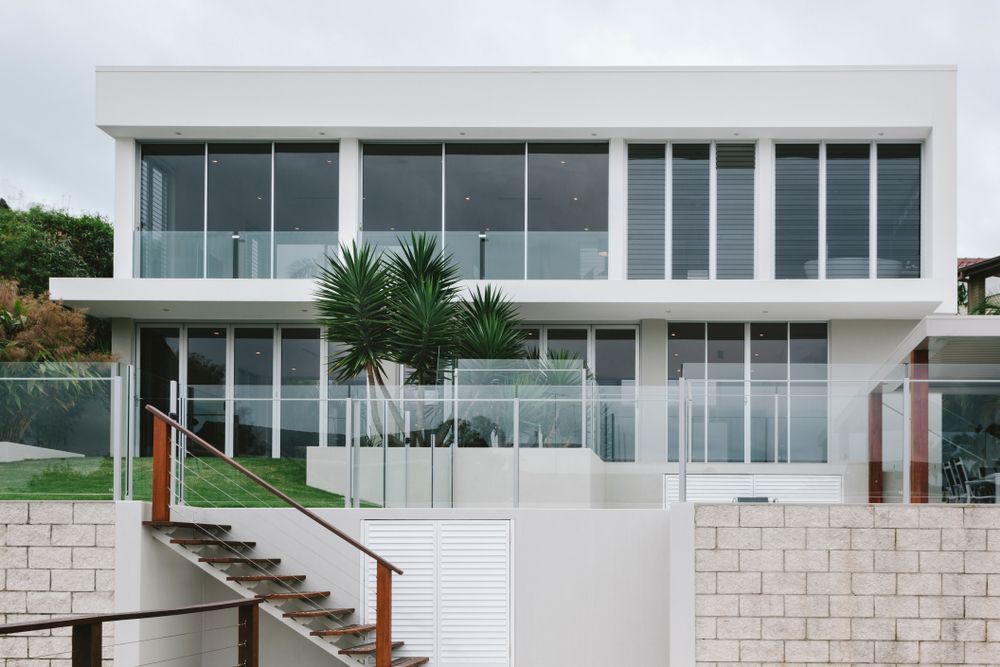 Modern White Two-story House With Glass Balcony — Wade Adams Constructions in Wingham, NSW