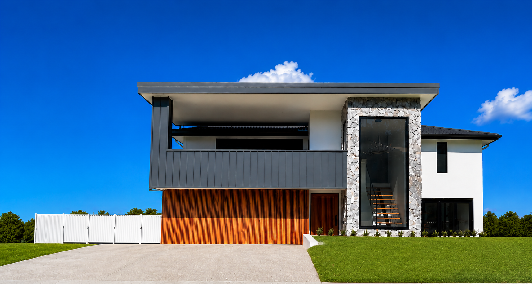 Modern two-story house with grey and white exterior, wood accents, and a manicured lawn — Wade Adams Constructions in Forster, NSW