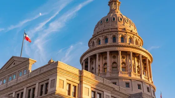 Court House — Wichita Falls, TX — Ostovich & Associates Texas State Capitol dome with Texas flag against a clear blue sky
