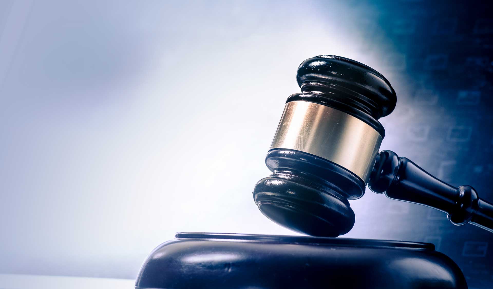 Judge’s gavel resting on a sound block, symbolizing law and justice.