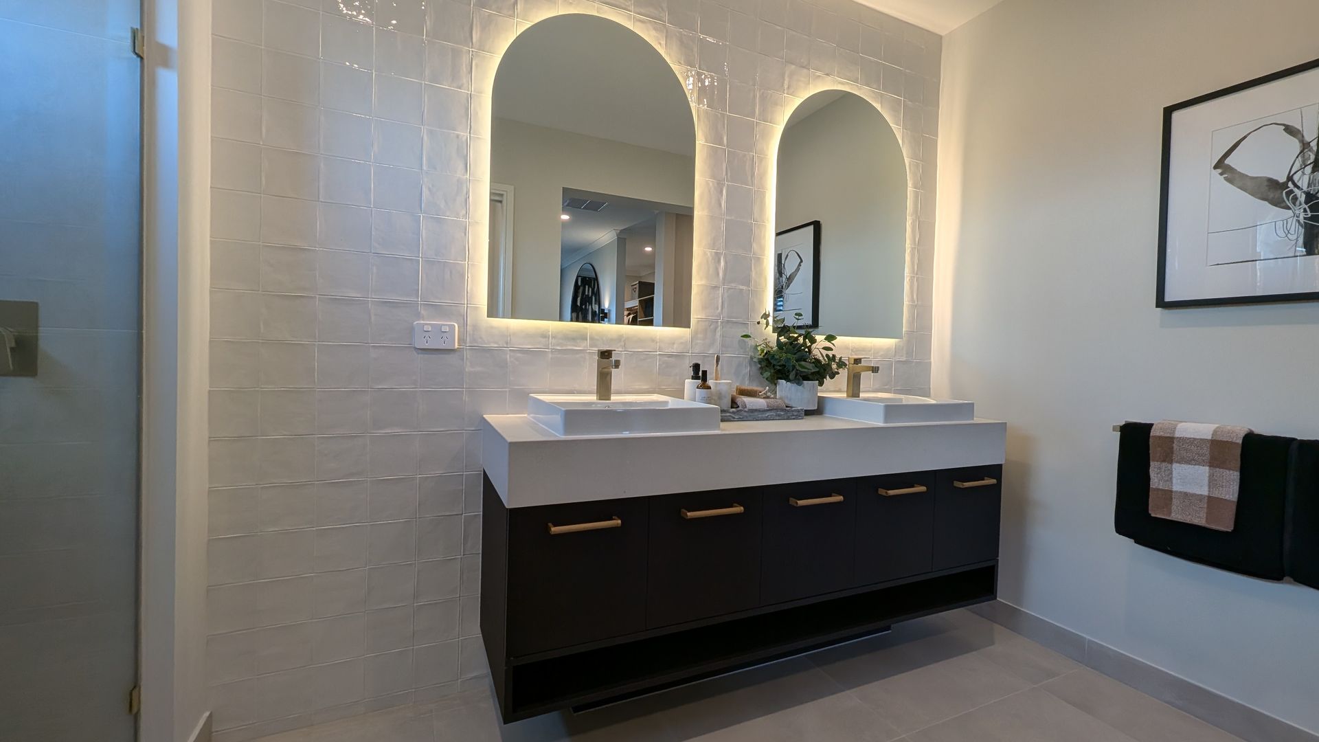 A bathroom with two sinks and two mirrors.