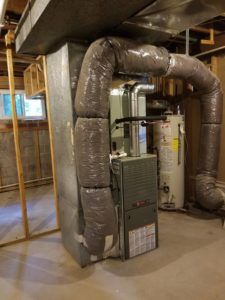 Air Conditioner Installation from Strive Heating & Cooling with Strive truck in the background.