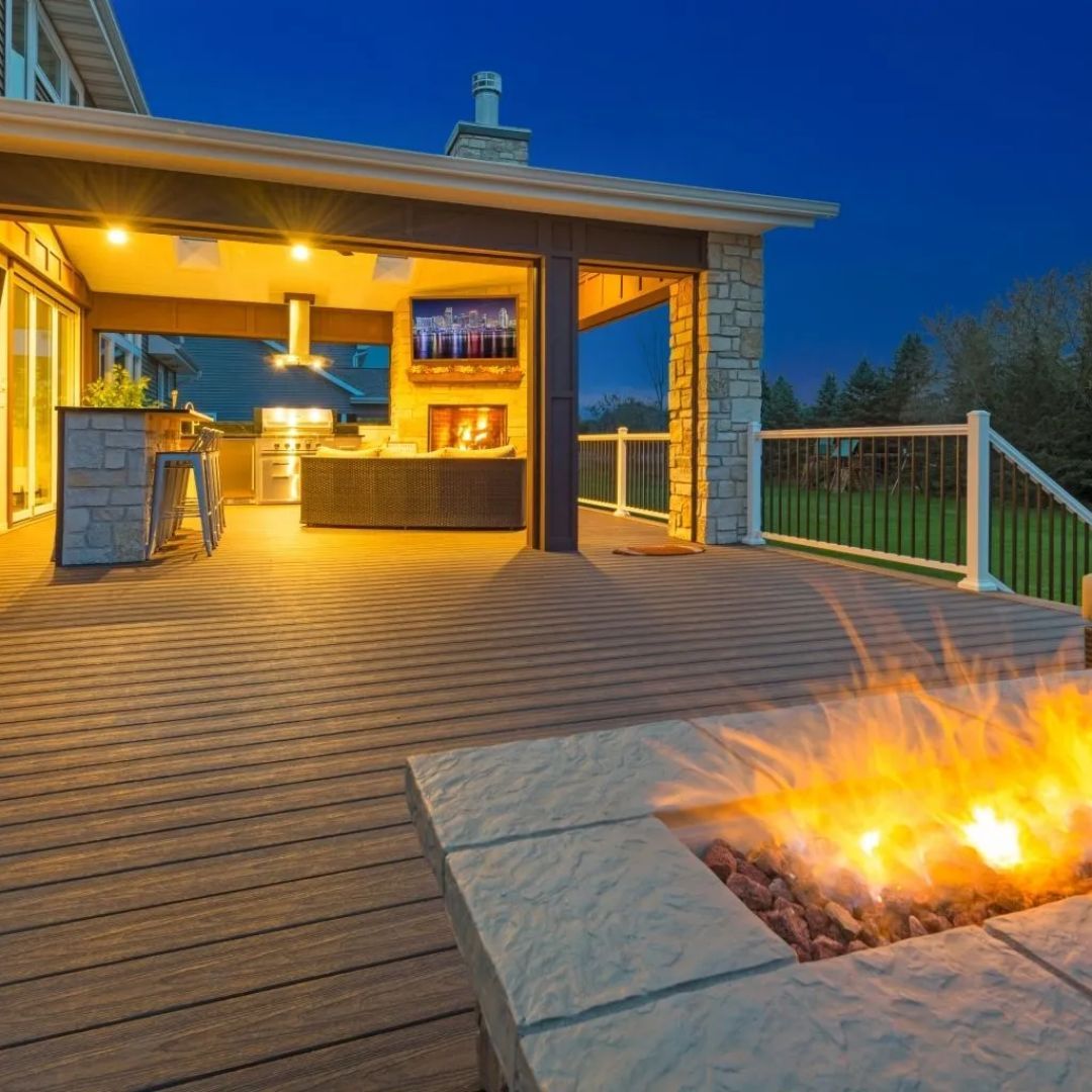 A deck with a fire pit in the middle of it
