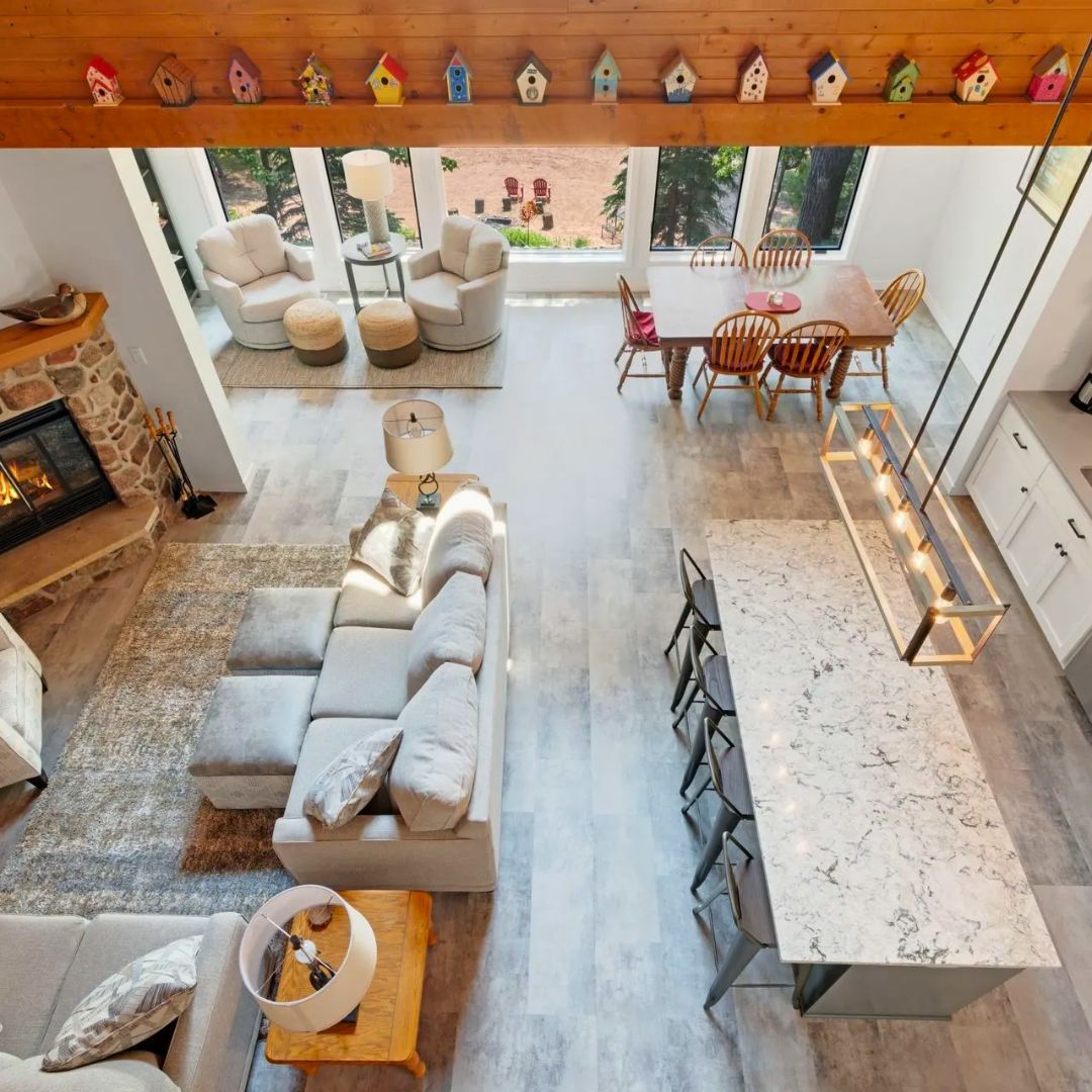 An aerial view of a living room and dining room in a house.
