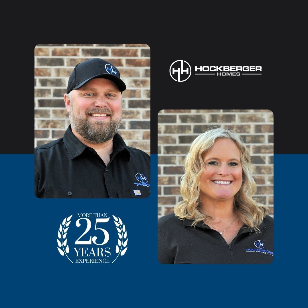 A man and a woman are standing next to each other with a 25 years logo in the background