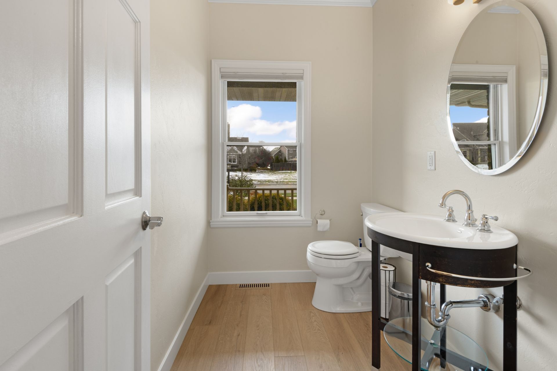 A bathroom with a toilet , sink and mirror