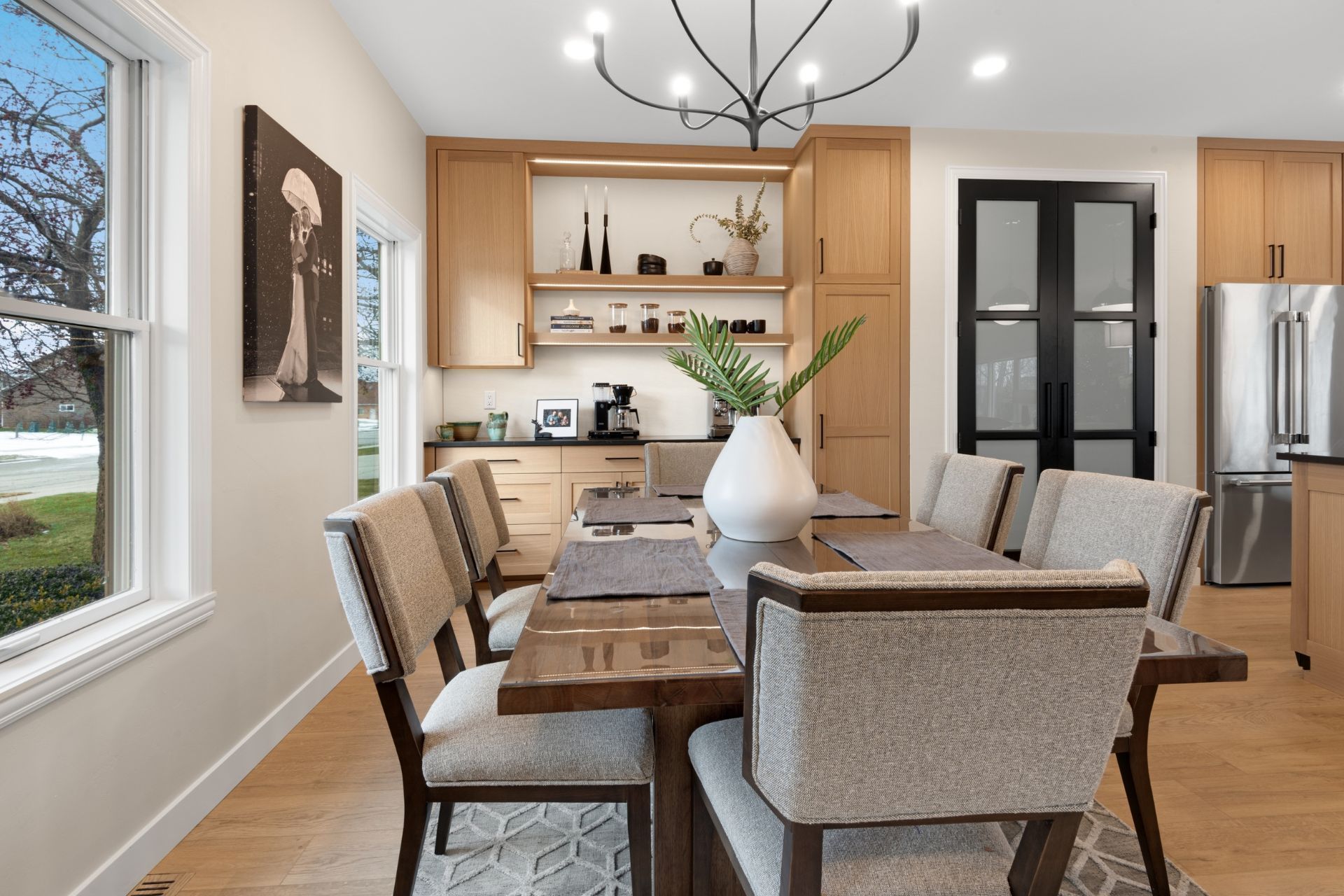 A dining room with a table and chairs and a chandelier.