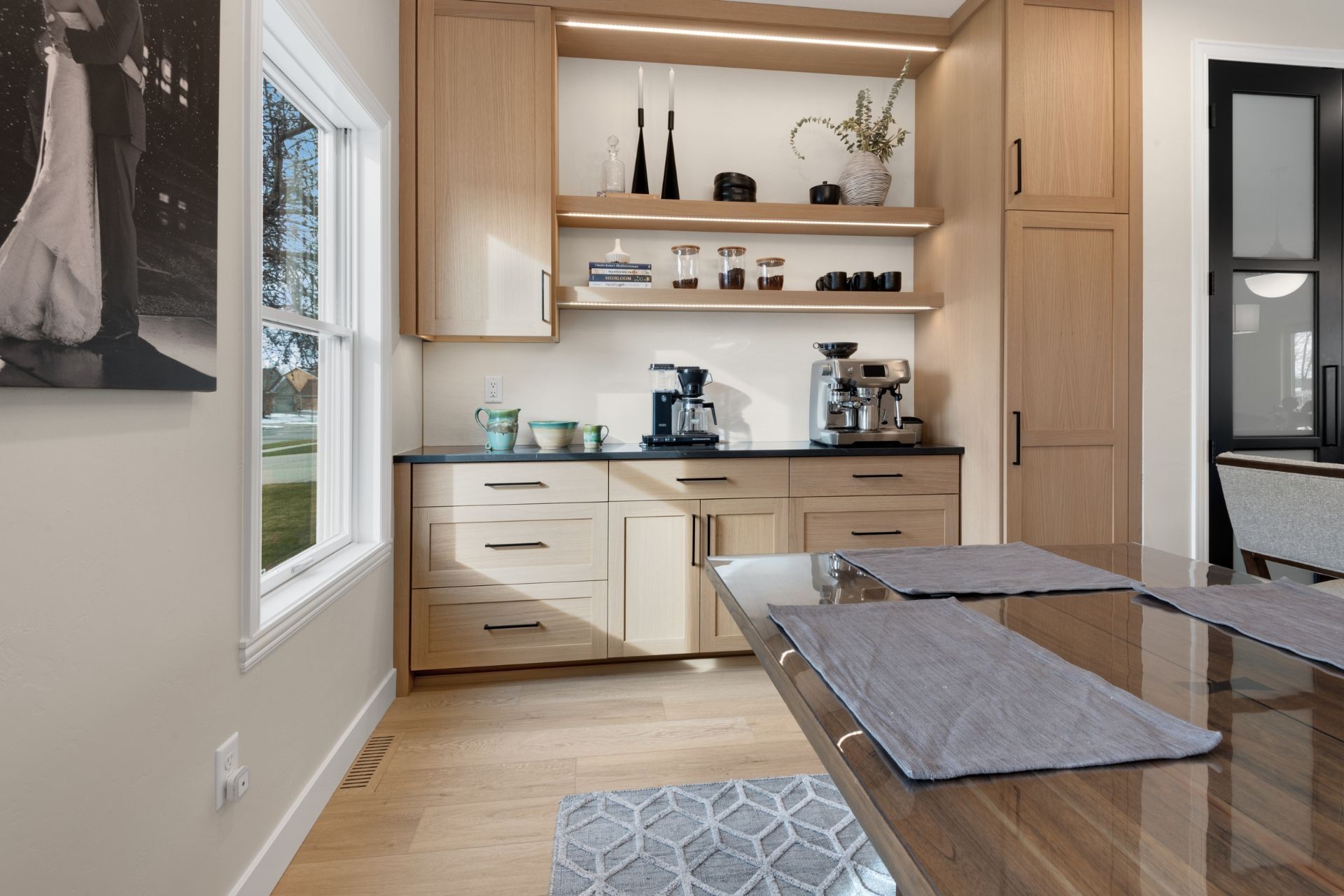 A kitchen with a table and a coffee maker