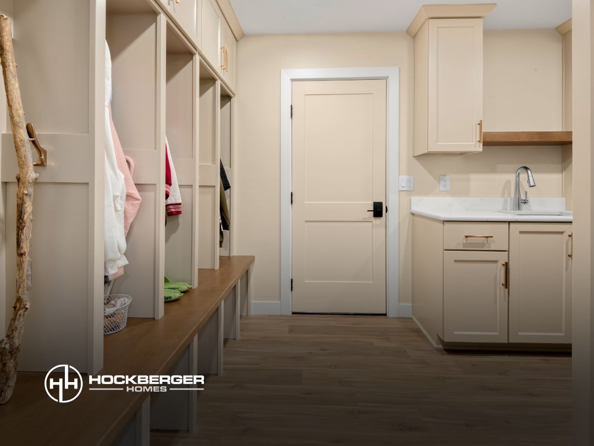 A laundry room with lots of cabinets and a sink.