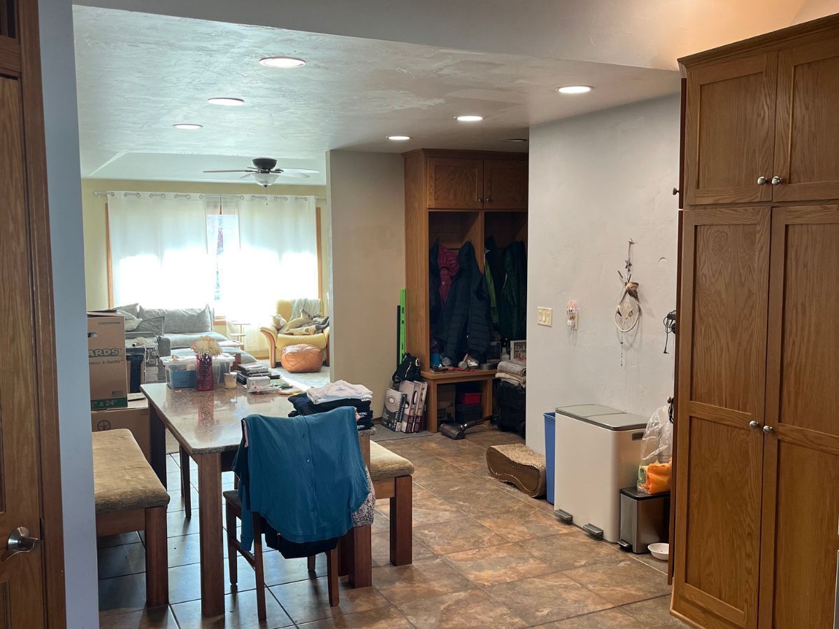 There is a table and chairs in the middle of the room.