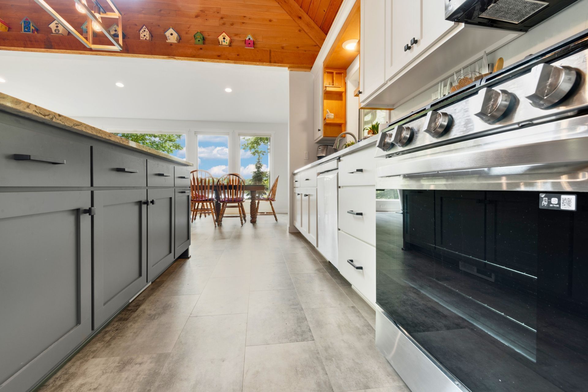 A kitchen with stainless steel appliances and gray cabinets