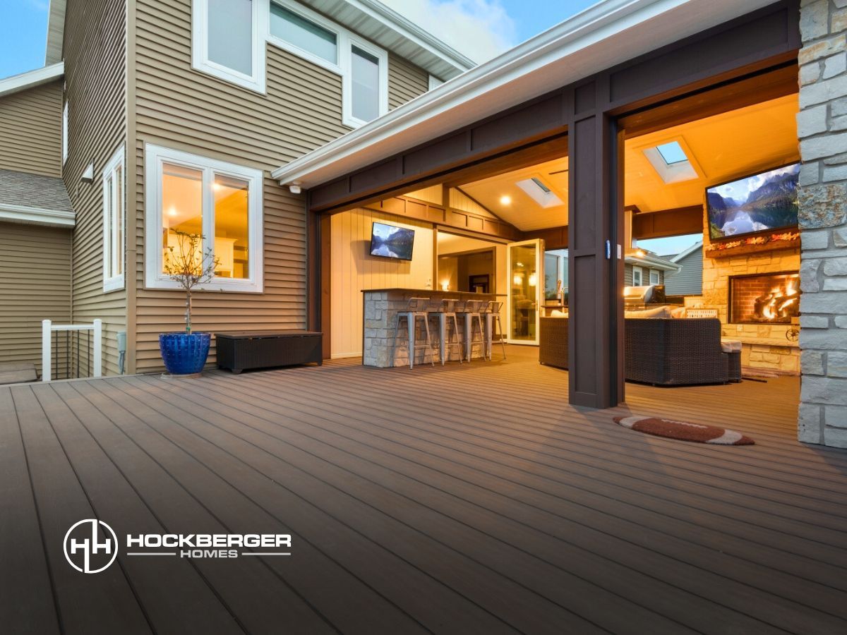 A house with a large deck and sliding glass doors