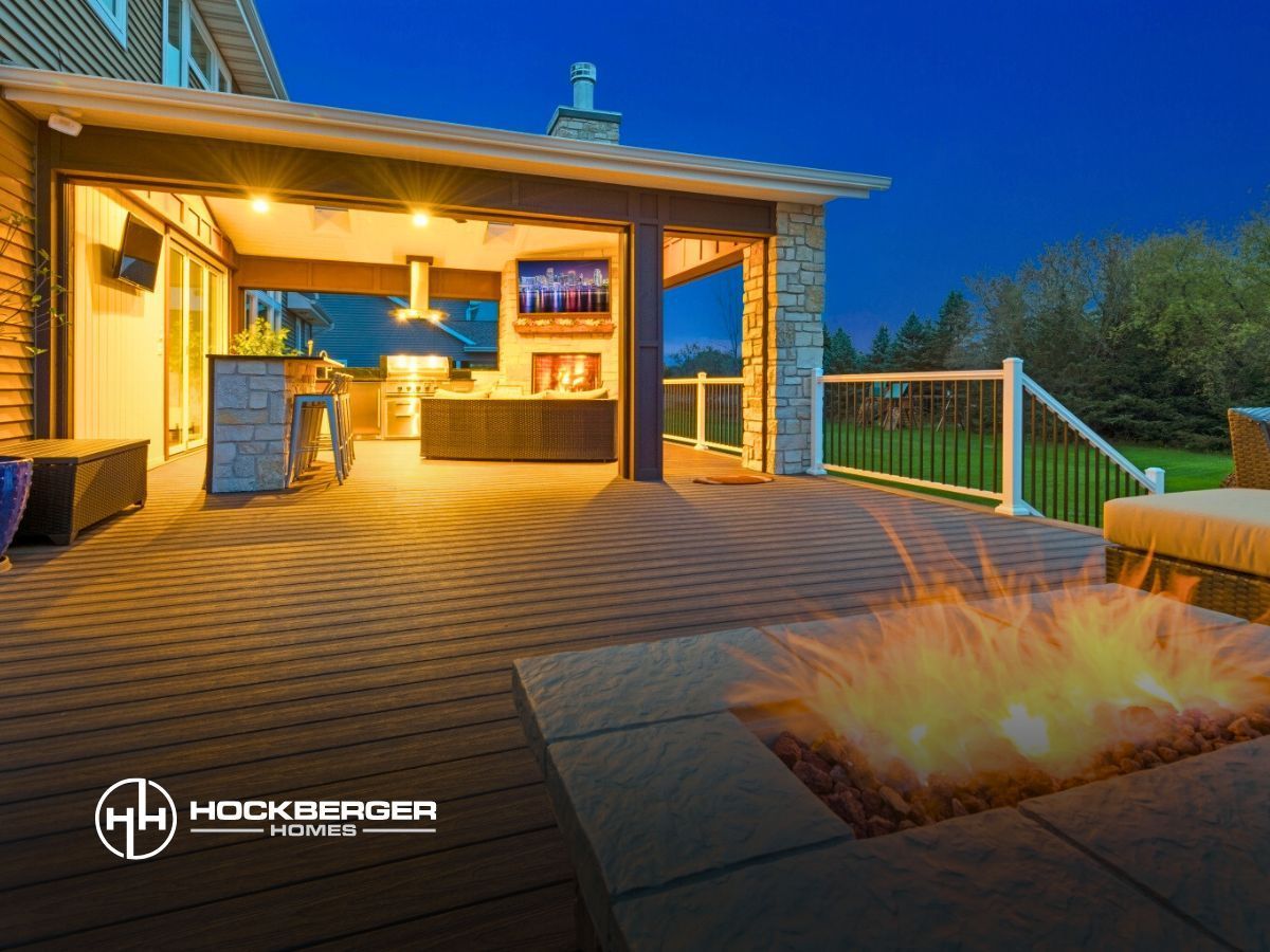 There is a fire pit on the deck of a house.