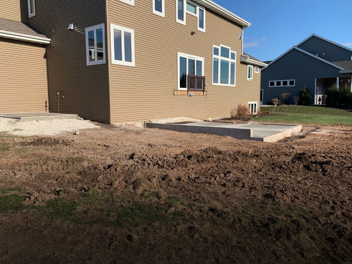 A house with a lot of dirt in front of it.