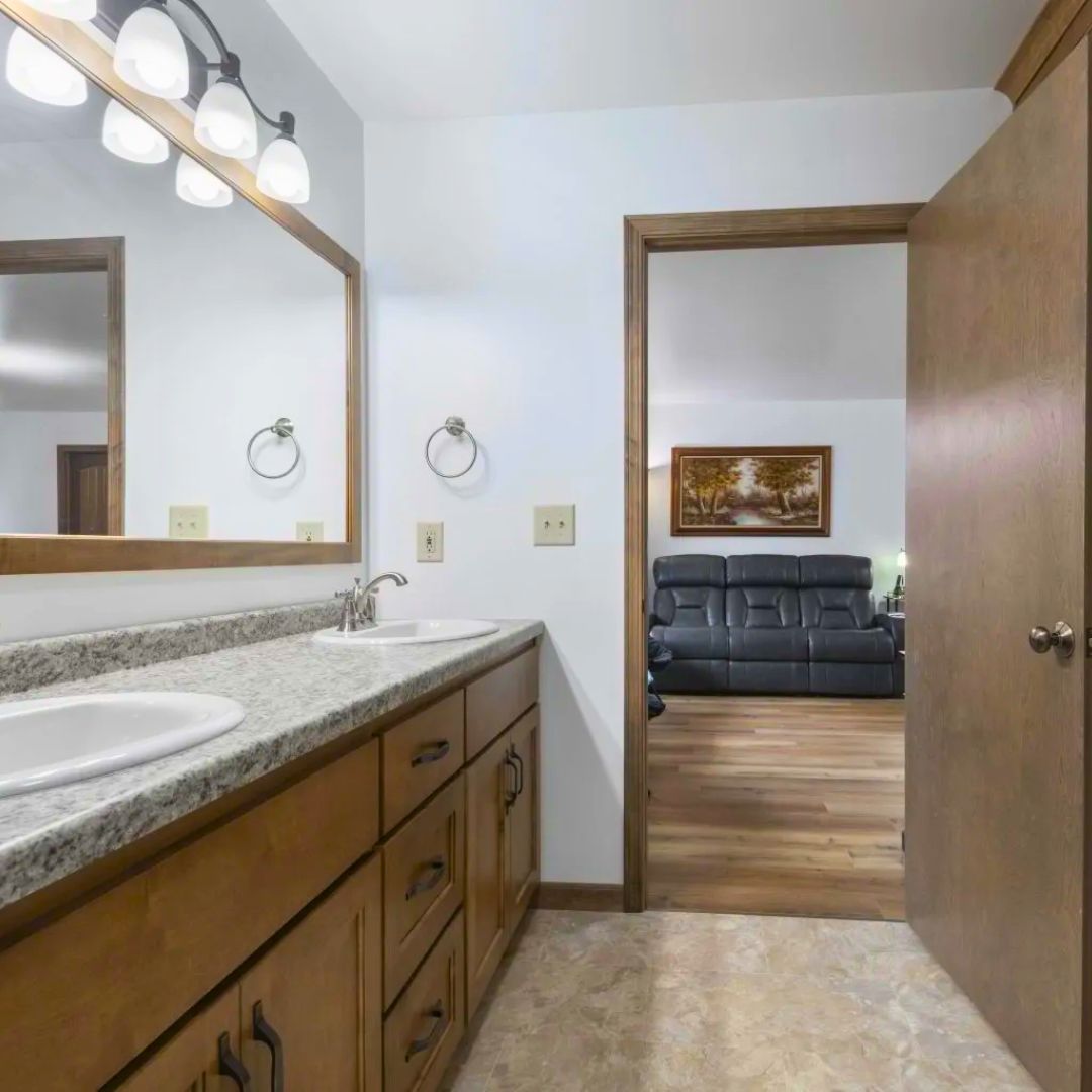 A bathroom with two sinks and a large mirror