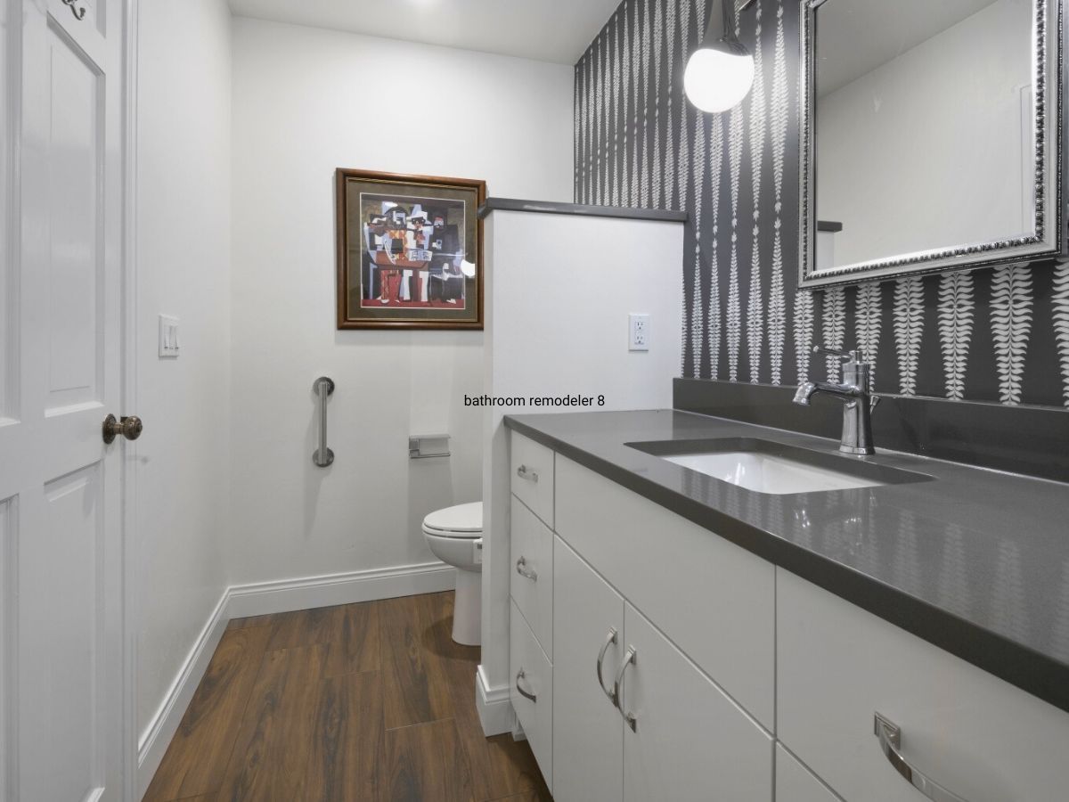 A bathroom with a toilet , sink and mirror