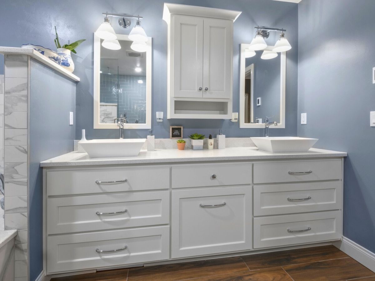 A bathroom with two sinks and two mirrors.