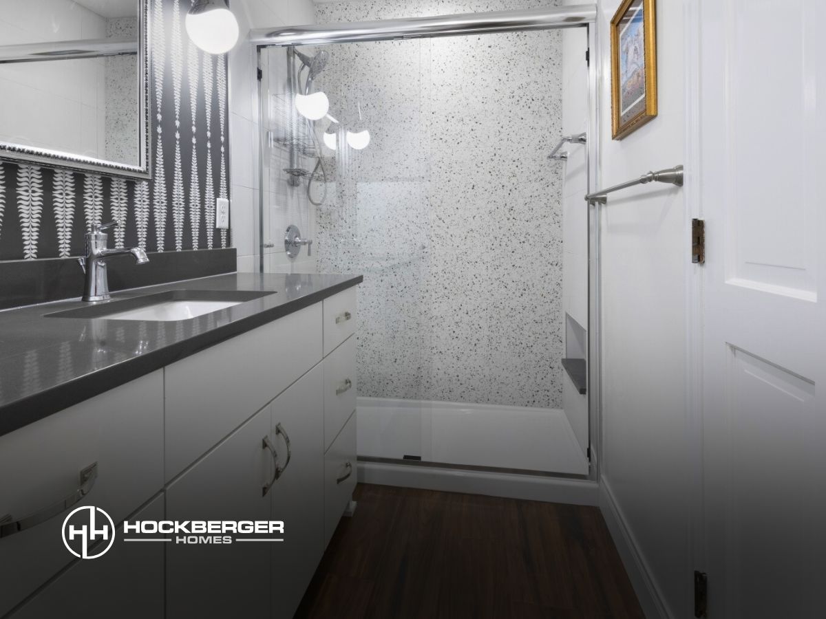 A bathroom with a sliding glass shower door
