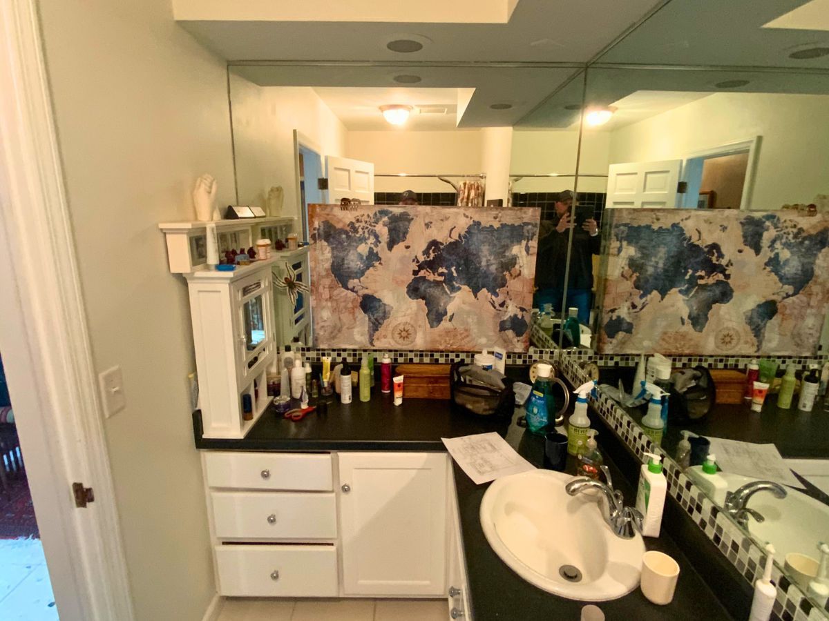 A bathroom with a sink and a map on the wall