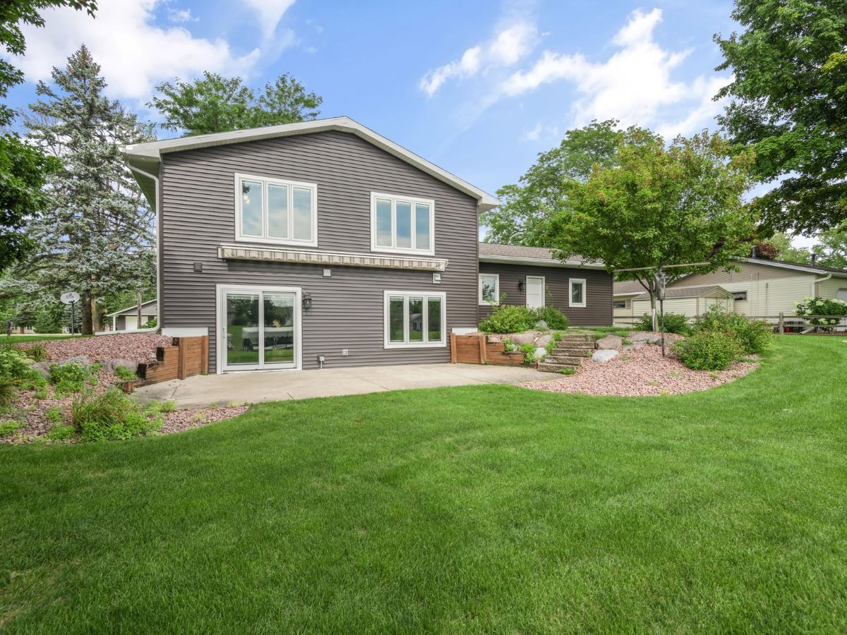 A large house with a large lawn in front of it.