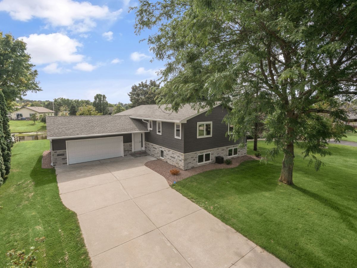 An aerial view of a house with a garage and a driveway.